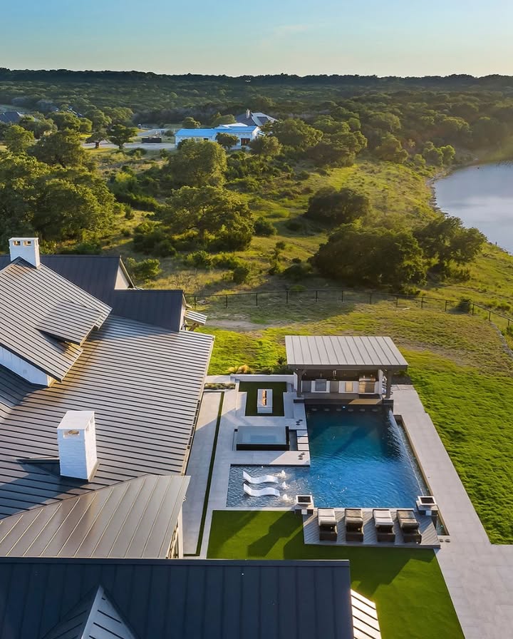 Drone view of a lakeside pool and pavilion