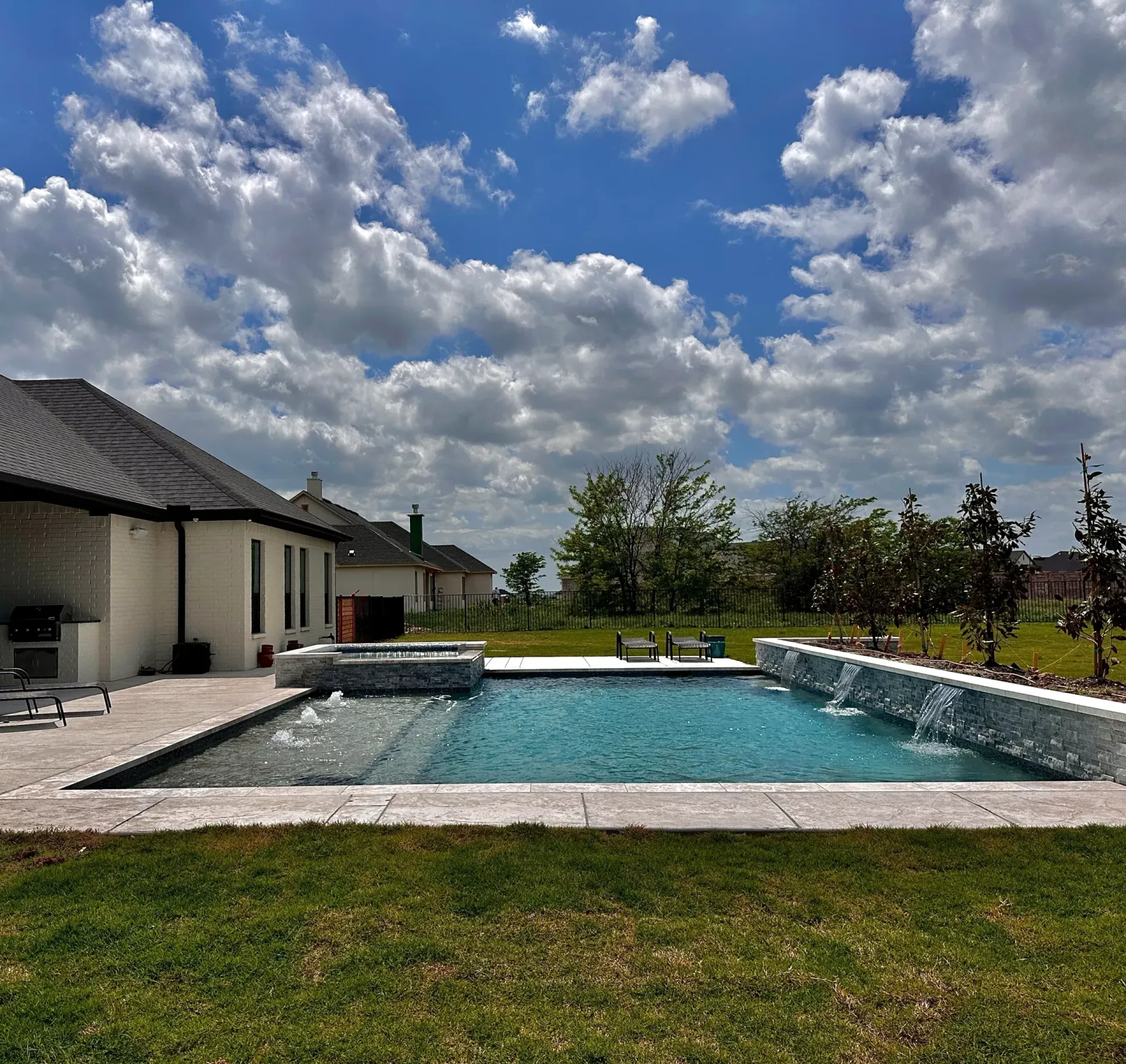 Pool with a waterfall under dramatic clouds