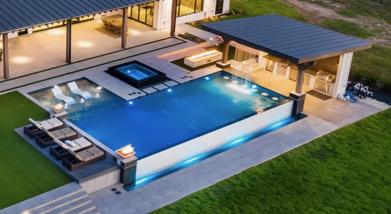 Aerial view of a large pool with spa, fire feature and loungers