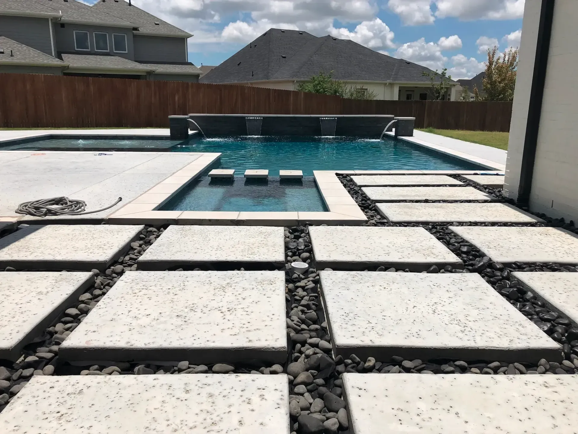 Modern pool with stepping-stone coping and water scuppers