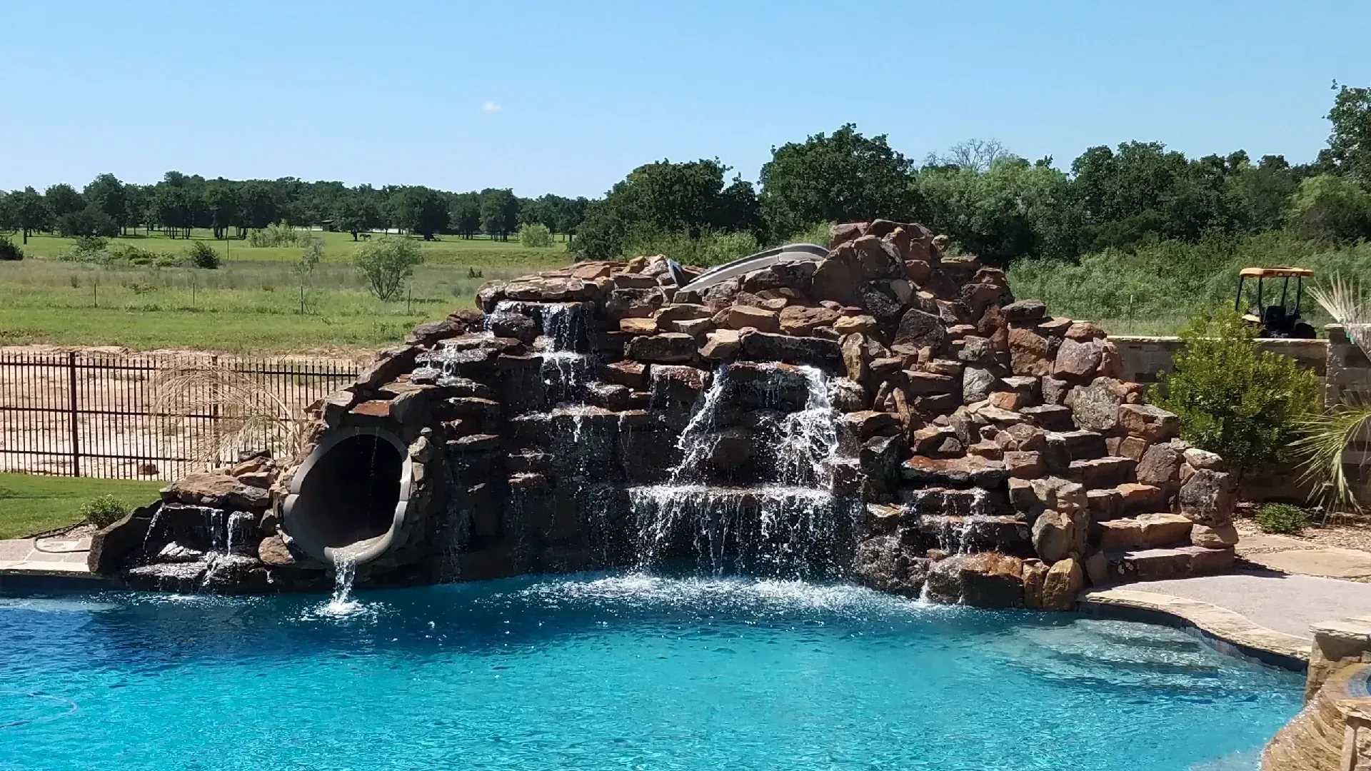 Rock waterfall and grotto over a pool