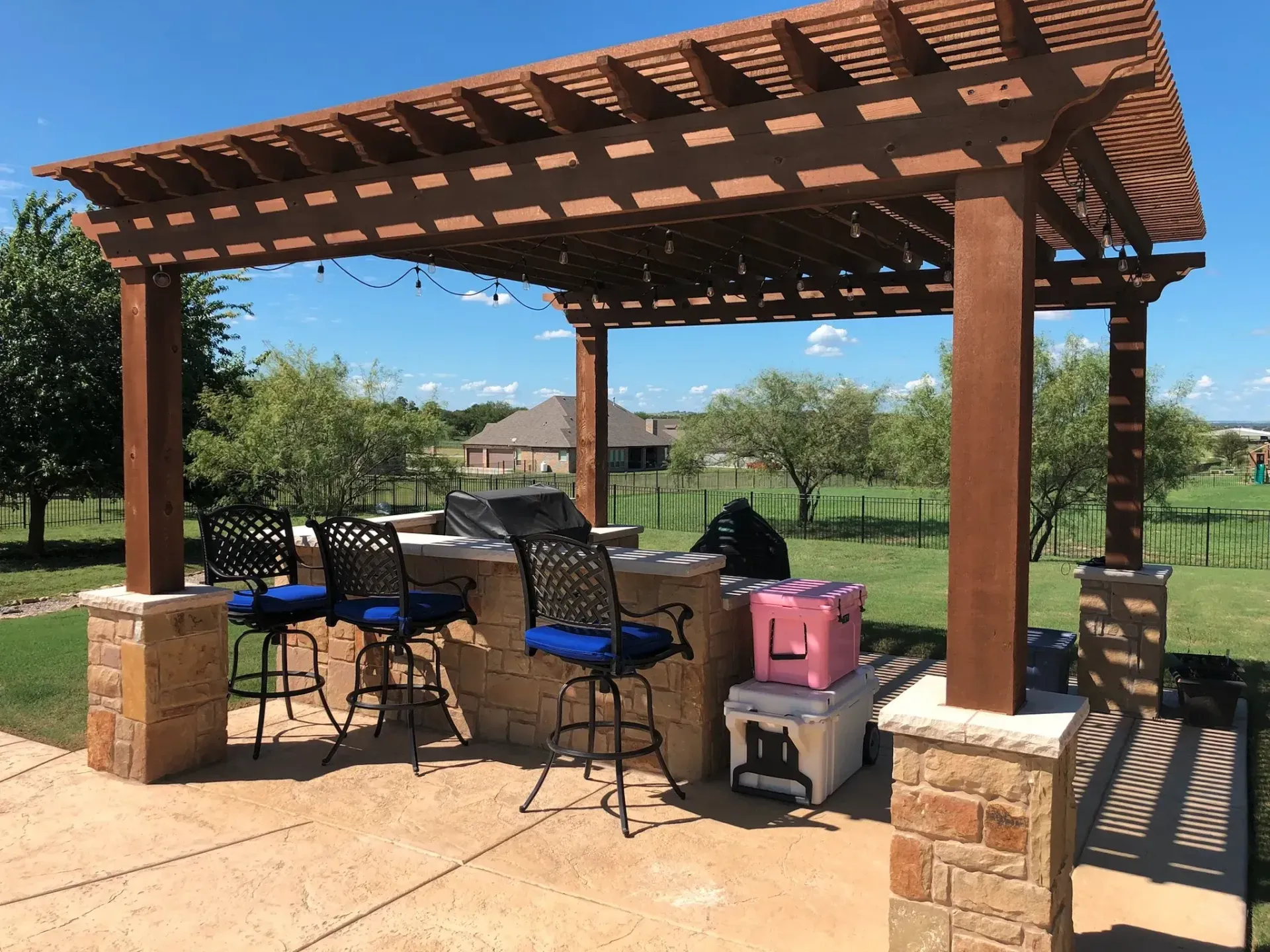 Pergola with an outdoor kitchen and bar seating